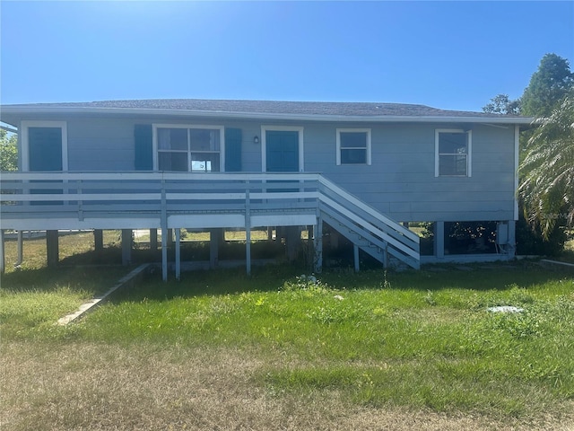 14330 Ellerbee St, Winter Garden, FL 34787 - rear view of property featuring a lawn, stairway, and a deck