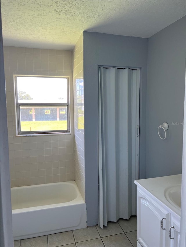 14330 Ellerbee St, Winter Garden, FL 34787 - bathroom featuring tile patterned floors, vanity, and a textured ceiling
