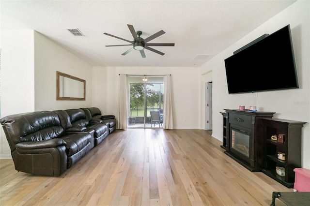 1089 Seburn Rd, Apopka, FL 32703 - living area with ceiling fan, light wood-type flooring, and a glass covered fireplace