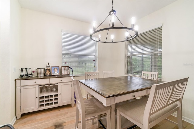 1089 Seburn Rd, Apopka, FL 32703 - dining area with a chandelier, light wood finished floors, healthy amount of natural light, and baseboards