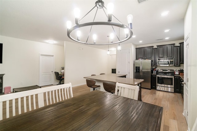 1089 Seburn Rd, Apopka, FL 32703 - dining area with a chandelier, light wood-style flooring, and recessed lighting