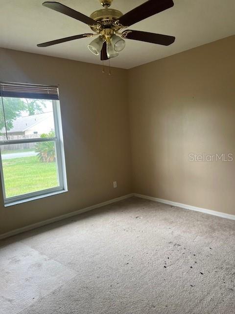 42 Banyan Pass, Ocala, FL 34472 - spare room featuring carpet, baseboards, and ceiling fan