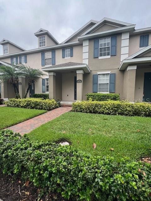 14531 Pleach St, Winter Garden, FL 34787 - view of front of house with stucco siding and a front yard
