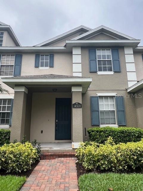 14531 Pleach St, Winter Garden, FL 34787 - view of exterior entry featuring stucco siding and a porch