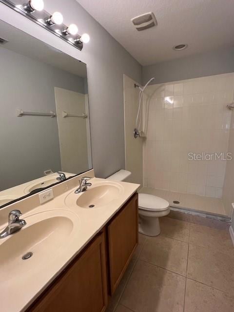 14531 Pleach St, Winter Garden, FL 34787 - bathroom with tiled shower, double vanity, and tile patterned floors