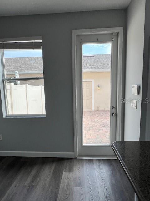 14531 Pleach St, Winter Garden, FL 34787 - doorway to outside with dark wood finished floors and baseboards