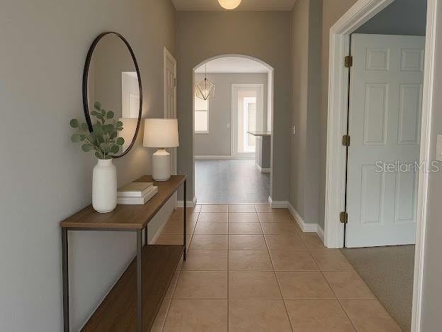 14531 Pleach St, Winter Garden, FL 34787 - hallway featuring arched walkways and light tile patterned flooring