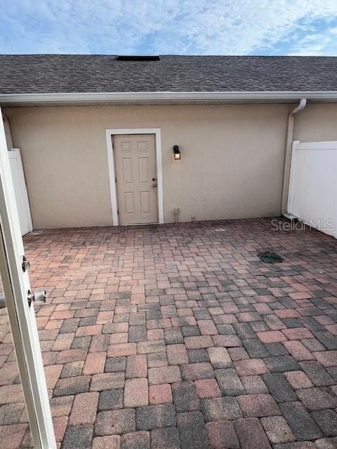 14531 Pleach St, Winter Garden, FL 34787 - view of exterior entry featuring stucco siding and a shingled roof