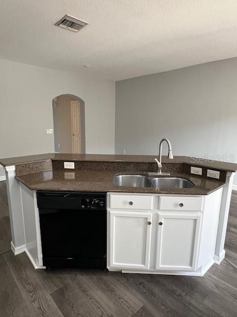 14531 Pleach St, Winter Garden, FL 34787 - kitchen featuring black dishwasher, dark wood-style floors, arched walkways, and white cabinets
