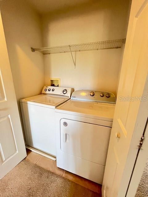 14531 Pleach St, Winter Garden, FL 34787 - laundry room featuring washer and clothes dryer and light tile patterned flooring