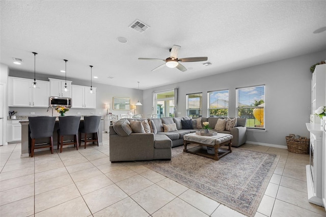 646 Marsh Reed Dr, Winter Garden, FL 34787 - living room with a ceiling fan, light tile patterned flooring, a textured ceiling, and recessed lighting