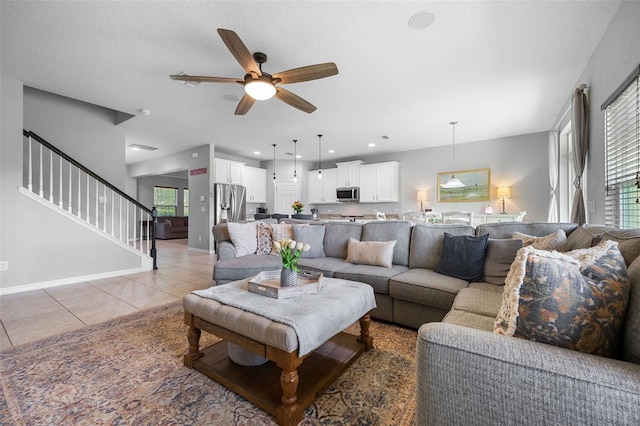 646 Marsh Reed Dr, Winter Garden, FL 34787 - living room featuring light tile patterned flooring, a ceiling fan, stairs, and recessed lighting