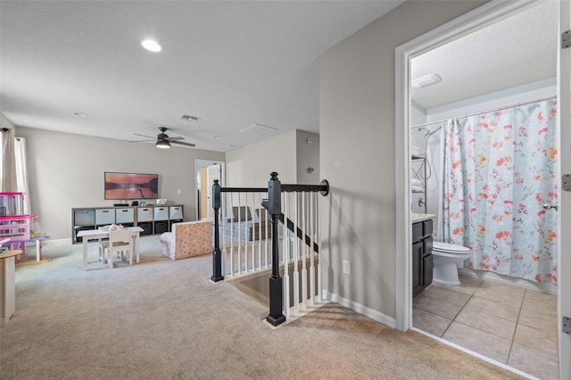646 Marsh Reed Dr, Winter Garden, FL 34787 - corridor featuring an upstairs landing, light colored carpet, a textured ceiling, and recessed lighting