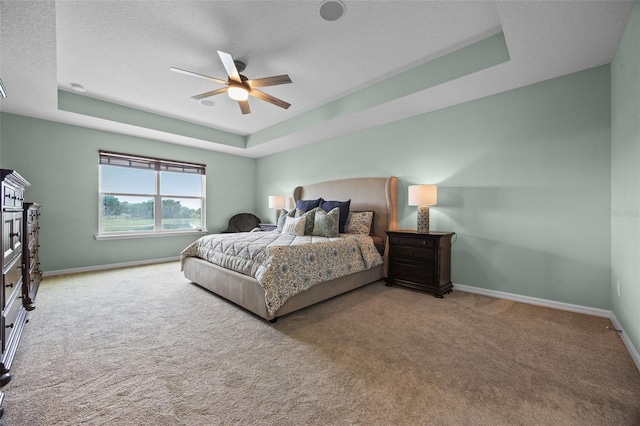 646 Marsh Reed Dr, Winter Garden, FL 34787 - bedroom featuring a tray ceiling, carpet floors, a textured ceiling, and ceiling fan
