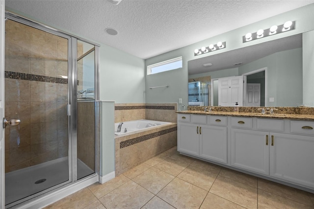 646 Marsh Reed Dr, Winter Garden, FL 34787 - bathroom featuring double vanity, a bath, a stall shower, tile patterned flooring, and a textured ceiling