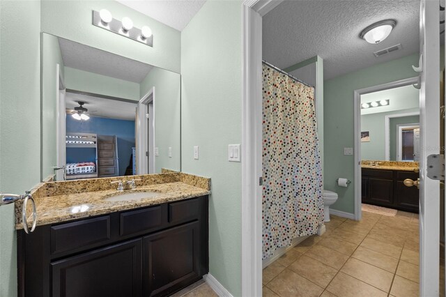 646 Marsh Reed Dr, Winter Garden, FL 34787 - ensuite bathroom featuring vanity, tile patterned flooring, a textured ceiling, a ceiling fan, and curtained shower