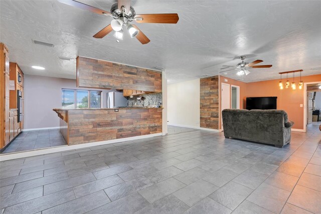 106 8th St, Lake Hamilton, FL 33851 - unfurnished living room with a ceiling fan and baseboards