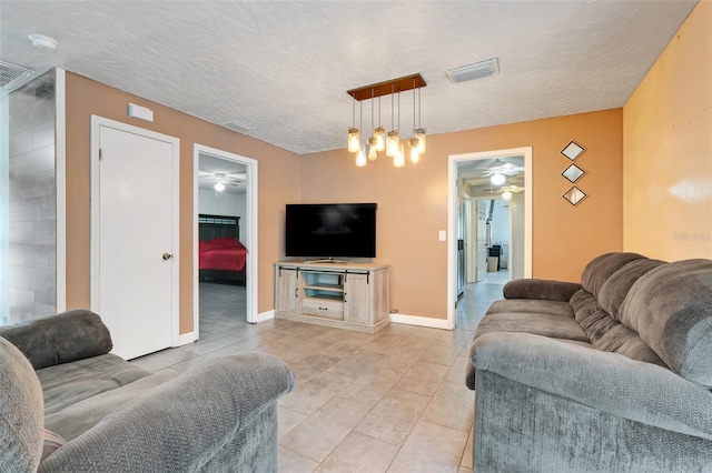 106 8th St, Lake Hamilton, FL 33851 - living room featuring a ceiling fan, light tile patterned floors, and baseboards