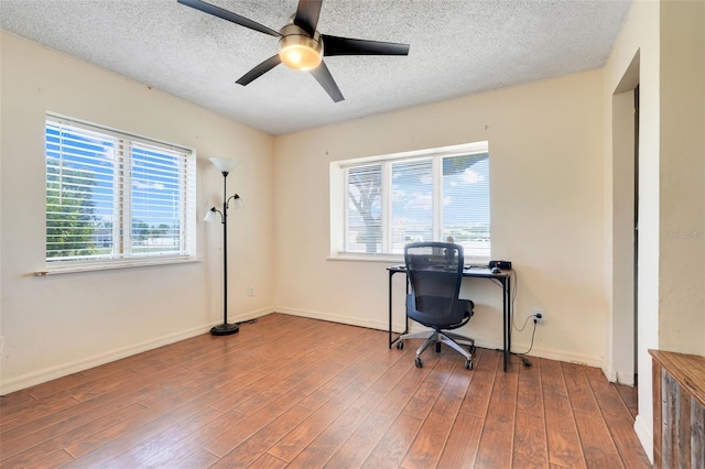106 8th St, Lake Hamilton, FL 33851 - home office featuring wood finished floors, a ceiling fan, a textured ceiling, and baseboards