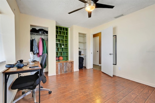 106 8th St, Lake Hamilton, FL 33851 - home office with ceiling fan, a textured ceiling, wood finished floors, built in features, and baseboards