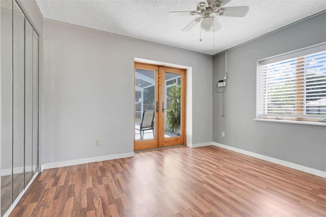 106 8th St, Lake Hamilton, FL 33851 - unfurnished room with wood finished floors, a ceiling fan, baseboards, a textured ceiling, and french doors