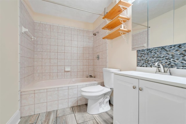 106 8th St, Lake Hamilton, FL 33851 - bathroom featuring tiled shower / bath, toilet, vanity, decorative backsplash, and wood finished floors
