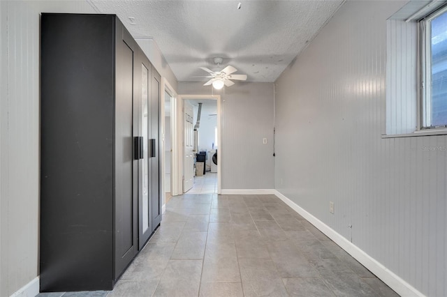 106 8th St, Lake Hamilton, FL 33851 - hallway with a textured ceiling, separate washer and dryer, baseboards, and light tile patterned flooring