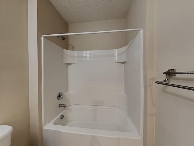 bathroom featuring a textured ceiling and toilet