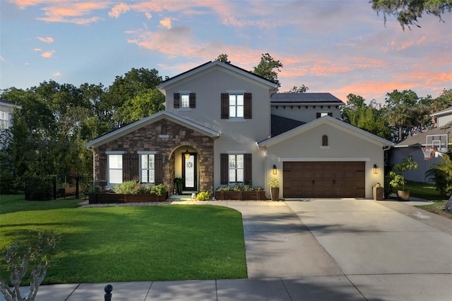 557 Lake Cove Pointe Cir, Winter Garden, FL 34787 - view of front facade featuring an attached garage, concrete driveway, stucco siding, and stone siding