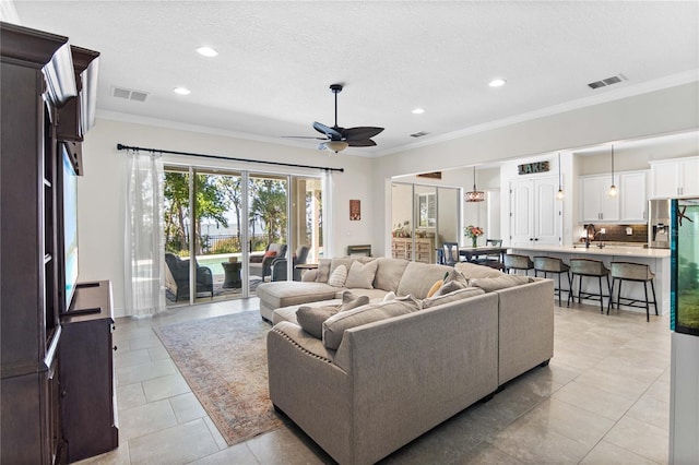 557 Lake Cove Pointe Cir, Winter Garden, FL 34787 - living room featuring ornamental molding, ceiling fan, recessed lighting, light tile patterned floors, and a textured ceiling