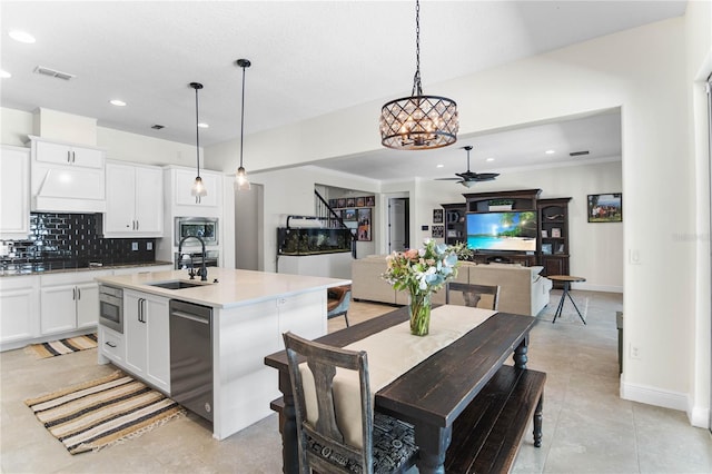 557 Lake Cove Pointe Cir, Winter Garden, FL 34787 - kitchen featuring a sink, a chandelier, appliances with stainless steel finishes, backsplash, and ceiling fan
