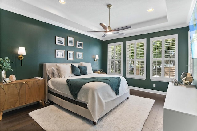 557 Lake Cove Pointe Cir, Winter Garden, FL 34787 - bedroom featuring wood finished floors, multiple windows, recessed lighting, a tray ceiling, and ornamental molding