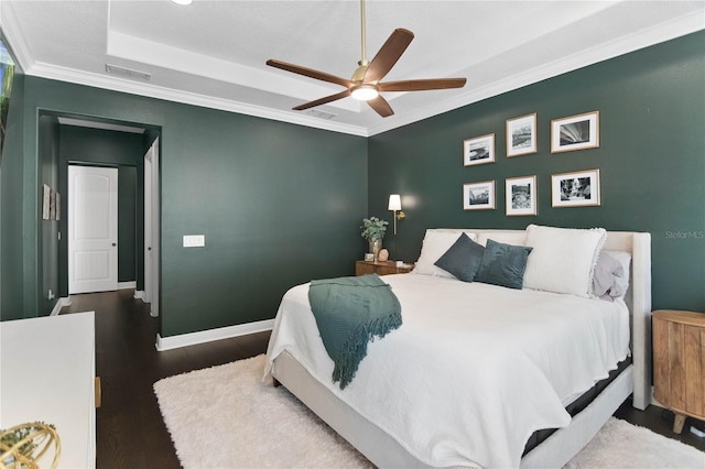 557 Lake Cove Pointe Cir, Winter Garden, FL 34787 - bedroom with wood finished floors, a tray ceiling, baseboards, ceiling fan, and crown molding