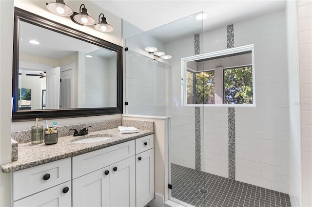 557 Lake Cove Pointe Cir, Winter Garden, FL 34787 - full bath with a tile shower, vanity, and ceiling fan
