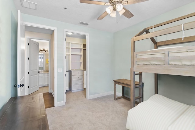 557 Lake Cove Pointe Cir, Winter Garden, FL 34787 - carpeted bedroom featuring baseboards, a walk in closet, and a closet