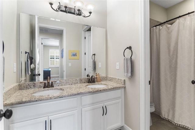 557 Lake Cove Pointe Cir, Winter Garden, FL 34787 - bathroom featuring double vanity, toilet, and tile patterned flooring