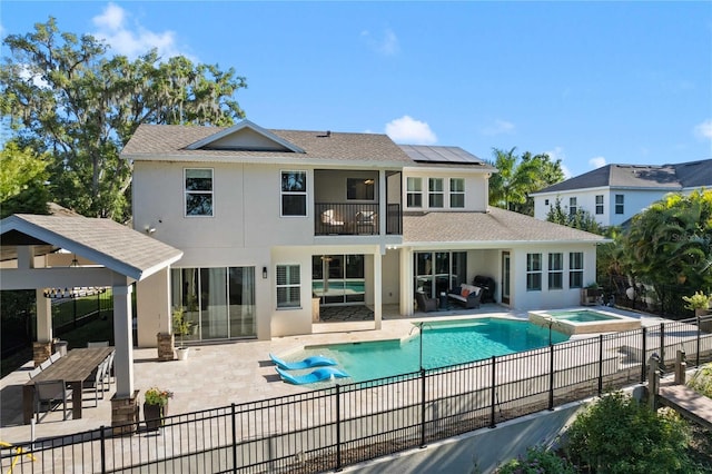 557 Lake Cove Pointe Cir, Winter Garden, FL 34787 - back of house featuring a patio, solar panels, stucco siding, a balcony, and a gazebo