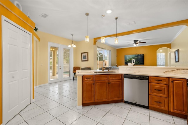 kitchen featuring dishwasher, a sink, open floor plan, light tile patterned floors, and brown cabinets