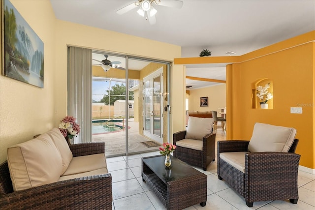 living area featuring ceiling fan and light tile patterned floors
