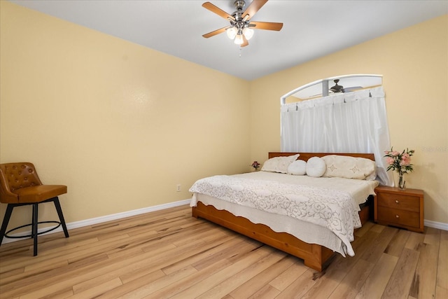 bedroom featuring light wood-type flooring, baseboards, and ceiling fan