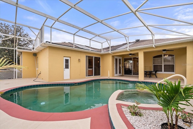 back of house featuring stucco siding, ceiling fan, a patio area, and a pool with connected hot tub