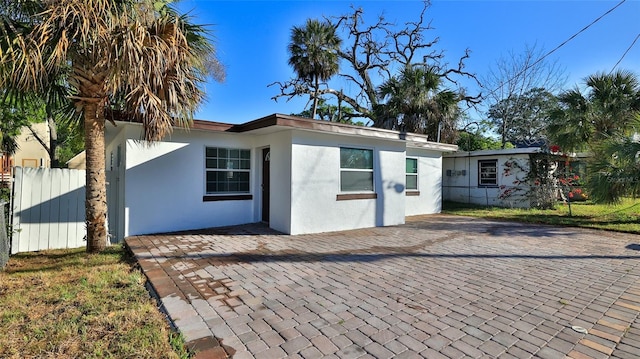 326 Hobart Ave, Daytona Beach, FL 32114 - view of side of property featuring stucco siding and fence