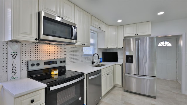 326 Hobart Ave, Daytona Beach, FL 32114 - kitchen featuring stainless steel appliances, a sink, white cabinets, backsplash, and recessed lighting