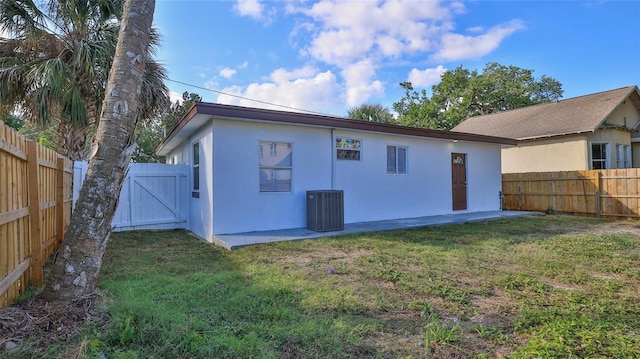326 Hobart Ave, Daytona Beach, FL 32114 - back of property with stucco siding, a gate, central AC, and a patio area