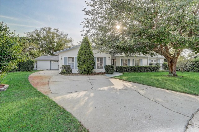 3100 Las Palmas Dr, Titusville, FL 32780 - view of front of property with driveway, a front yard, stucco siding, and an attached garage