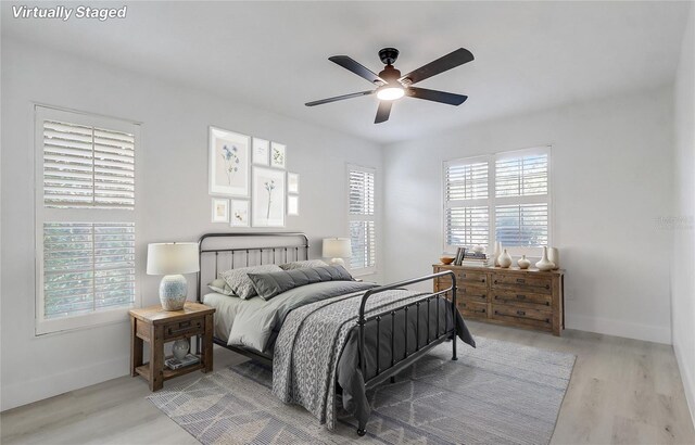 3100 Las Palmas Dr, Titusville, FL 32780 - bedroom with light wood-style flooring, baseboards, and a ceiling fan