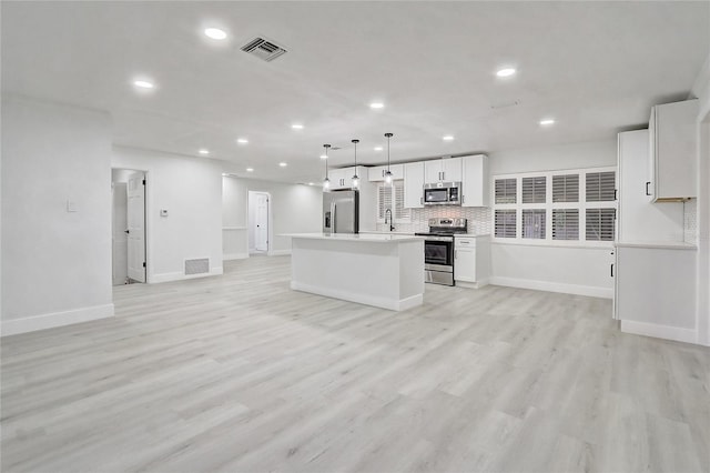 3100 Las Palmas Dr, Titusville, FL 32780 - kitchen featuring stainless steel appliances, open floor plan, recessed lighting, white cabinets, and a sink