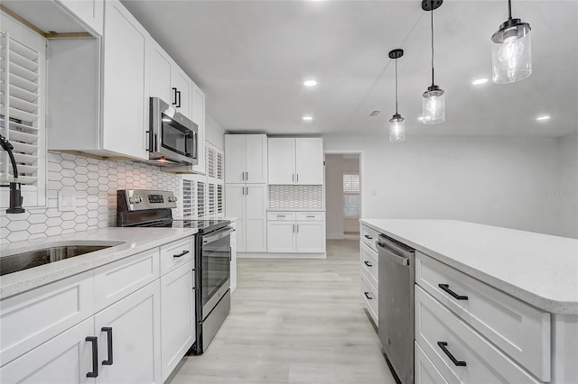 3100 Las Palmas Dr, Titusville, FL 32780 - kitchen with appliances with stainless steel finishes, backsplash, light wood-style flooring, recessed lighting, and a sink