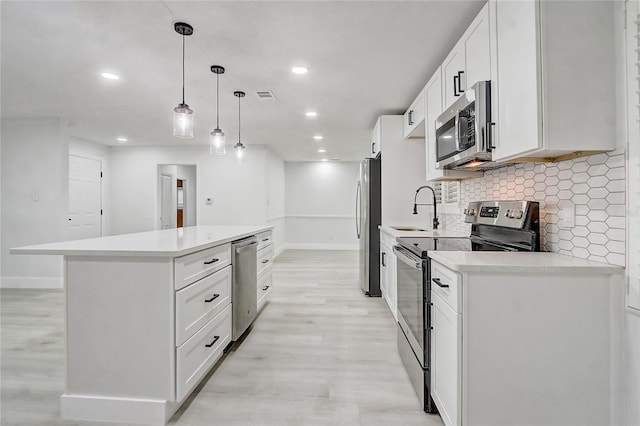 3100 Las Palmas Dr, Titusville, FL 32780 - kitchen with stainless steel appliances, a sink, a center island, decorative backsplash, and recessed lighting