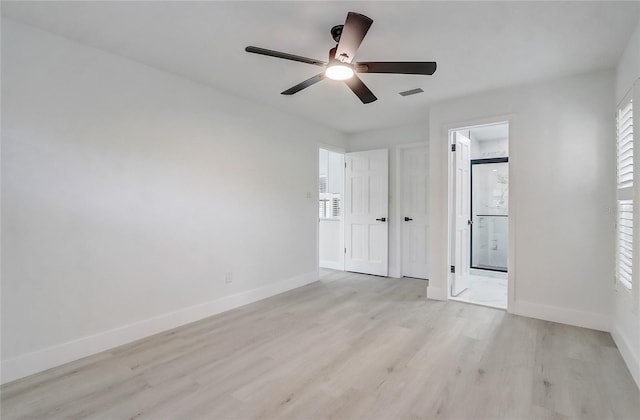 3100 Las Palmas Dr, Titusville, FL 32780 - unfurnished bedroom featuring light wood-style floors, baseboards, ensuite bathroom, and ceiling fan